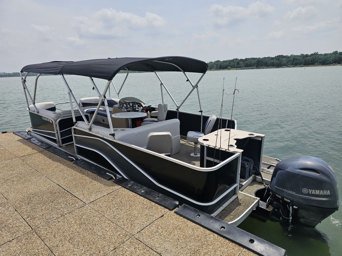 Side view of pontoon boat at the dock